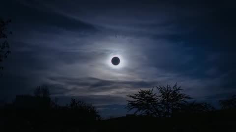 Showing total solar eclipse corona glowing over suburban skyline at twilight