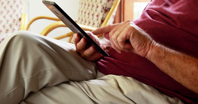 Senior Using Tablet While Relaxing in a Rocking Chair - Download Free Stock Images Pikwizard.com