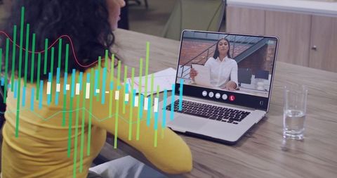 Woman attending virtual interview while data waveform overlays laptop workspace
