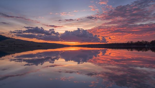 Vibrant Sunset Sky Reflects on Tranquil Lake