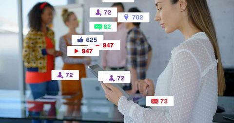 Woman tapping tablet during team meeting with social media notifications overlay