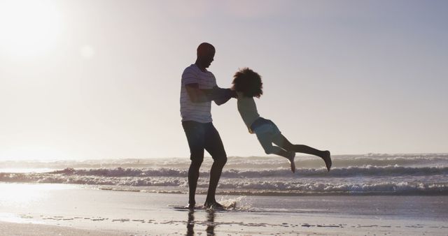 African american father and his daughter playing on the beach - Download Free Stock Photos Pikwizard.com