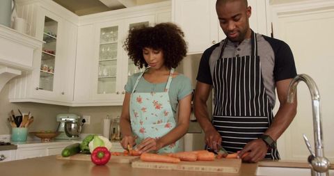 Couple Cooking Together, Chopping Vegetables in Contemporary Kitchen