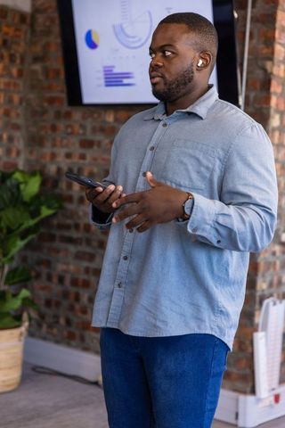 Business Professional Presenting Data Using Smartphone and Technology