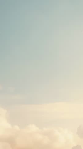 Vertical Sky Video: Golden Ornamental Clouds Drifting Over Pastel Horizon