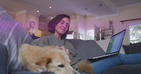 Woman Relaxing on Couch with Laptop in Cozy Living Room