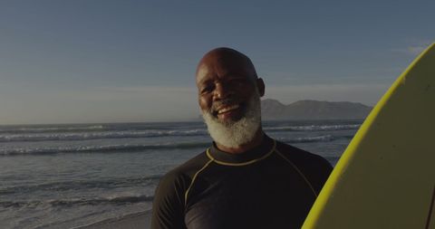 Senior Man Enjoying Surf at Beach During Christmas