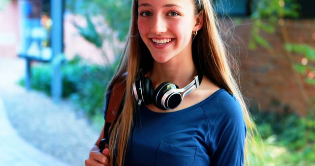Smiling Young Woman Outdoors with Headphones - Download Free Stock Images Pikwizard.com