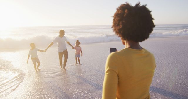 Happy Family Enjoying Vacation at Sandy Beach During Sunset - Download Free Stock Images Pikwizard.com