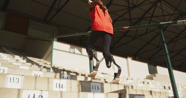 Determined athlete with prosthetic legs training on stadium stairs - Download Free Stock Images Pikwizard.com