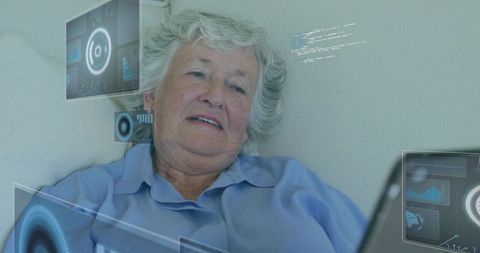 Senior woman embracing modern technology with laptop and digital interface