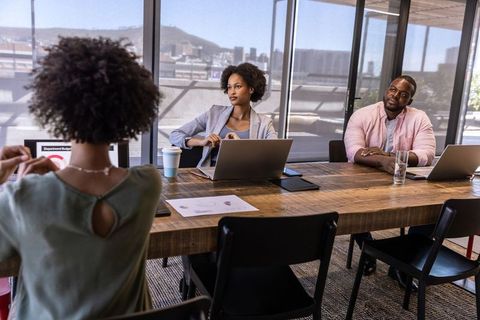Professionals Collaborating in Modern Office with City View
