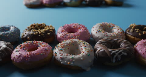 Bright Donuts with Sprinkles on Blue Backdrop