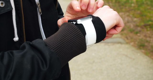 Individual Adjusting Smartwatch Strap While Outside - Download Free Stock Images Pikwizard.com