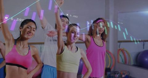 Diverse group raising arms in fitness class with data overlay and colorful activewear studio workout