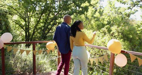 Interracial couple celebrating engagement on sunny terrace