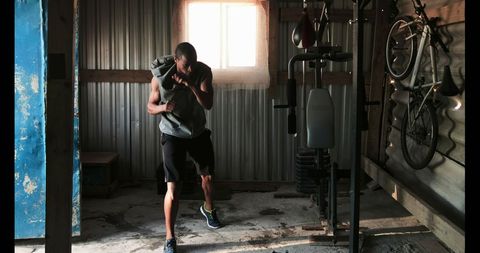 Young Boxer Practicing in Gym Wearing Casual Sportswear