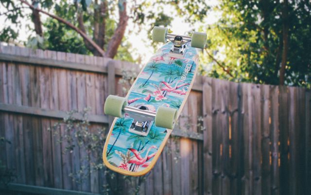 Colorful Skateboard with Tropical Design Flying in Mid-Air - Download Free Stock Photos Pikwizard.com