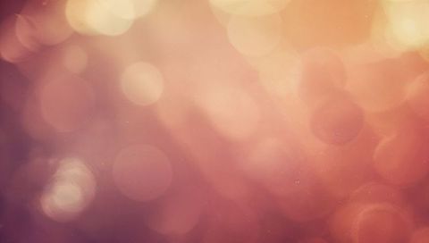 Shimmering Warm Pastel Bokeh Glow Featuring Soft Grain and Halo Lens Flare