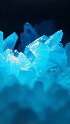 Shifting Reveal of Luminous Blue Crystal Cluster under LED Glow, Vertical Motion Loop