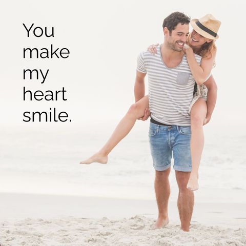 Joyful couple embracing playful beach moment