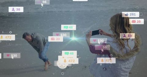 Woman Photographing Man on Beach with Social Media Notifications