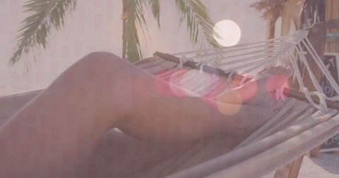 Relaxing in Hammock by Tropical Beach with Palm Trees