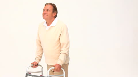 Smiling Retired Man Using Walker on White Backdrop