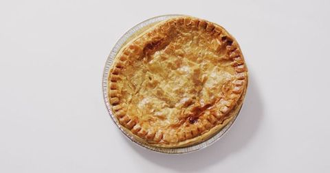 Golden crust savory pie on white background