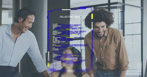 Diverse team collaborating around laptop with holographic COLLECTING DATA interface in modern office