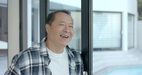 Mature Man Enjoying Leisure Moment by Modern Patio