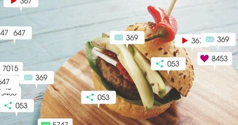 Gourmet avocado burger attracting social media notifications, likes and shares overlays
