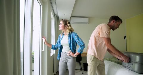 Couple preparing luggage in modern bright interior
