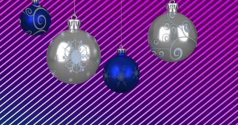 Hanging metallic blue and silver christmas baubles glinting on neon striped gradient background