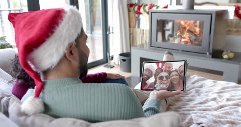 Family Connecting with Diverse Friends via Video Call on Christmas