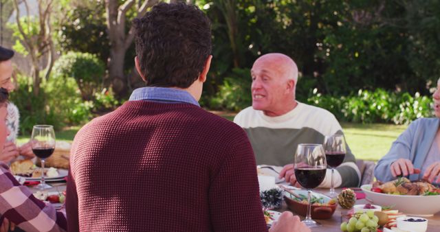 Family Enjoying Outdoor Meal in Garden Near Lush Greenery - Download Free Stock Images Pikwizard.com