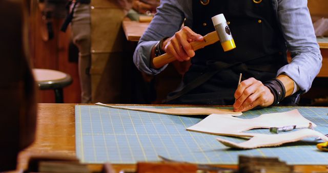 Craftsman Working on Leather with Hammer in Workshop - Download Free Stock Images Pikwizard.com