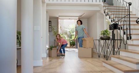 Joyful Couple Celebrating in New Home with Moving Boxes