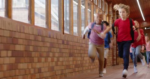 Energetic School Kids Running in Corridor