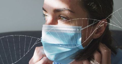 Female healthcare worker adjusting surgical mask with dna helix overlay closeup portrait
