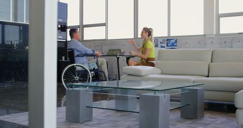 Casual office meeting between colleagues in modern lounge