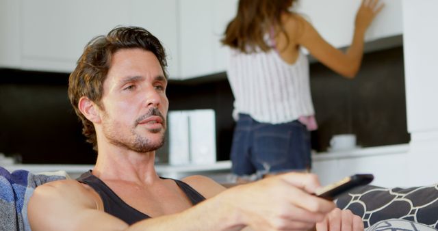 Man Relaxing on Couch Watching TV in Cozy Home - Download Free Stock Images Pikwizard.com