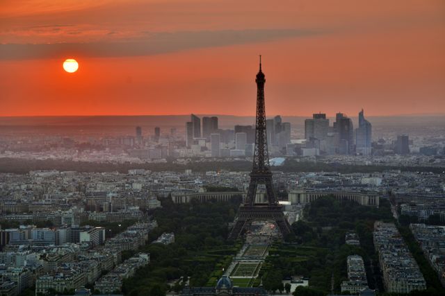 Eiffel Tower during sunset with the Paris skyline in the background. Perfect for travel brochures, advertising, posters, and websites promoting Paris as a travel destination. The blend of natural colors and urban appeal makes it ideal for romantic and cultural features.