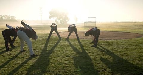 Baseball Team Stretching Together During Warm Sunrise