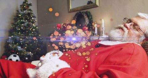 Tired santa napping on cozy sofa after toy run with christmas tree, wreath, plush toy