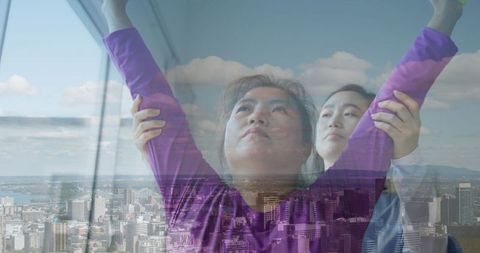 Asian Physiotherapist Assisting Woman with Stretches Over Cityscape