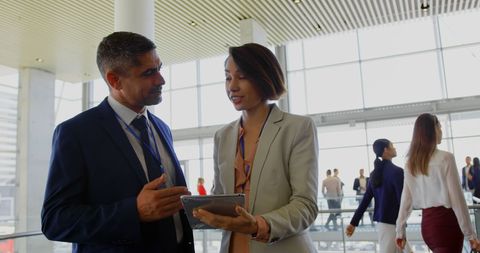 Business Professionals Discussing Digital Tablet in Office Lobby - Download Free Stock Images Pikwizard.com