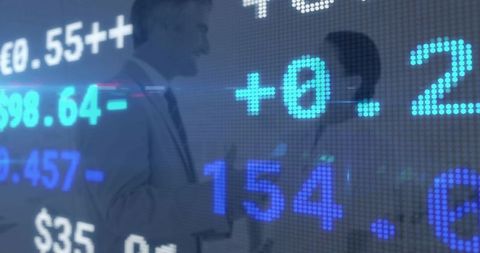 Business leaders shaking hands with digital stock ticker overlay conveying corporate deal