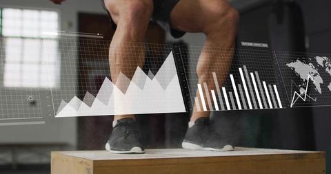 Male athlete performing explosive box jump with digital performance analytics overlay