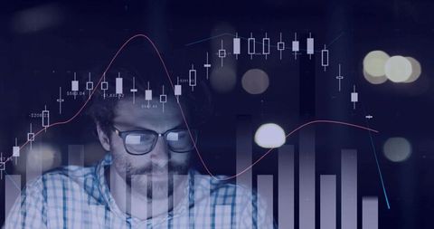 Financial analyst monitoring stock market charts at night with data visualization overlays